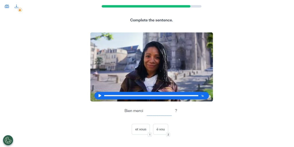 Video clip showing a Franco-African woman standing near a Gothic cathedral. Below is a fill-in exercise that asks the user to complete the sentence by choosing between two spelling options.